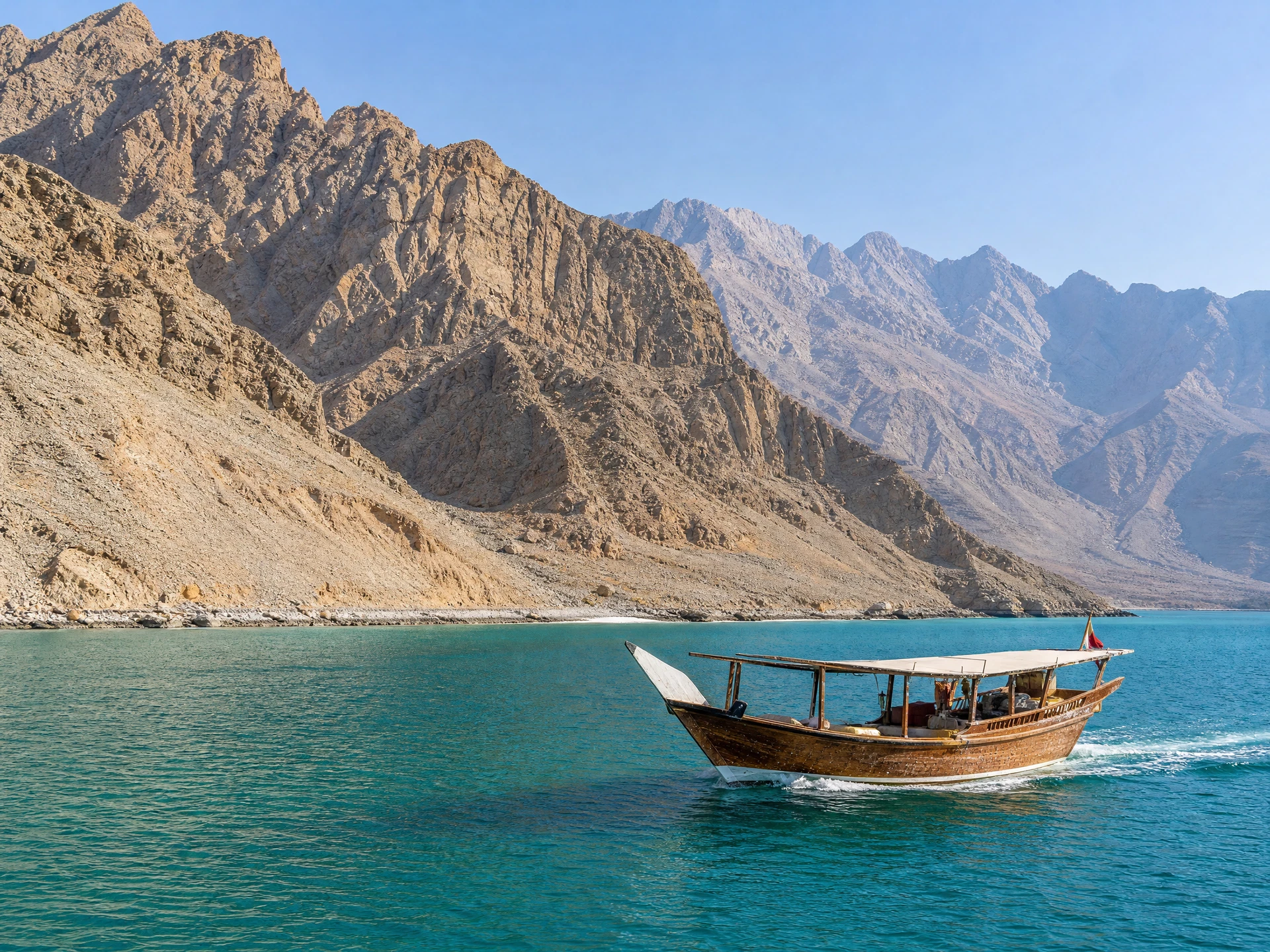 Illustrative traditional dhow on turquoise water beside Musandam mountains