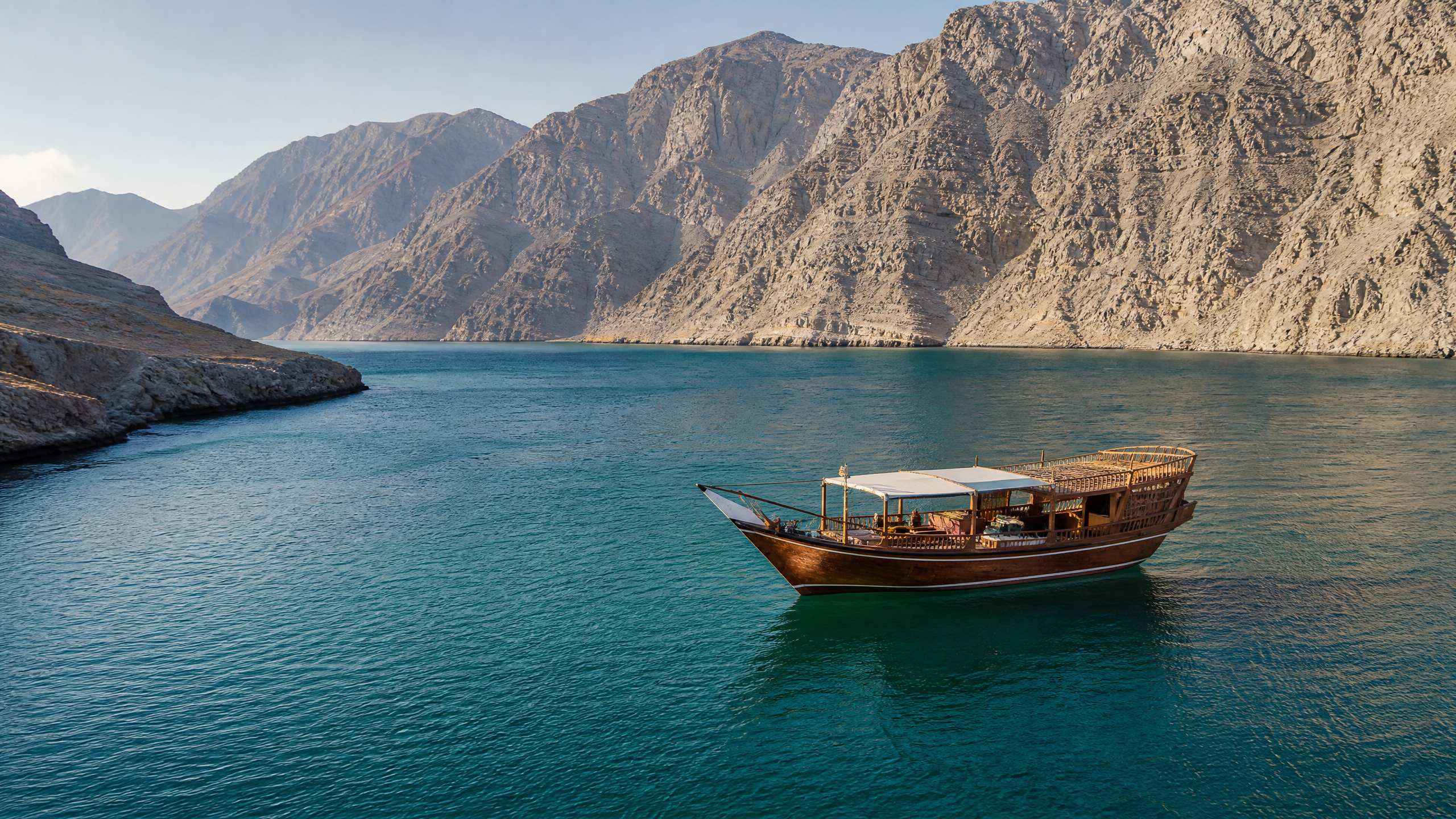 Traditional dhow cruise on turquoise water in Musandam Dibba, Oman